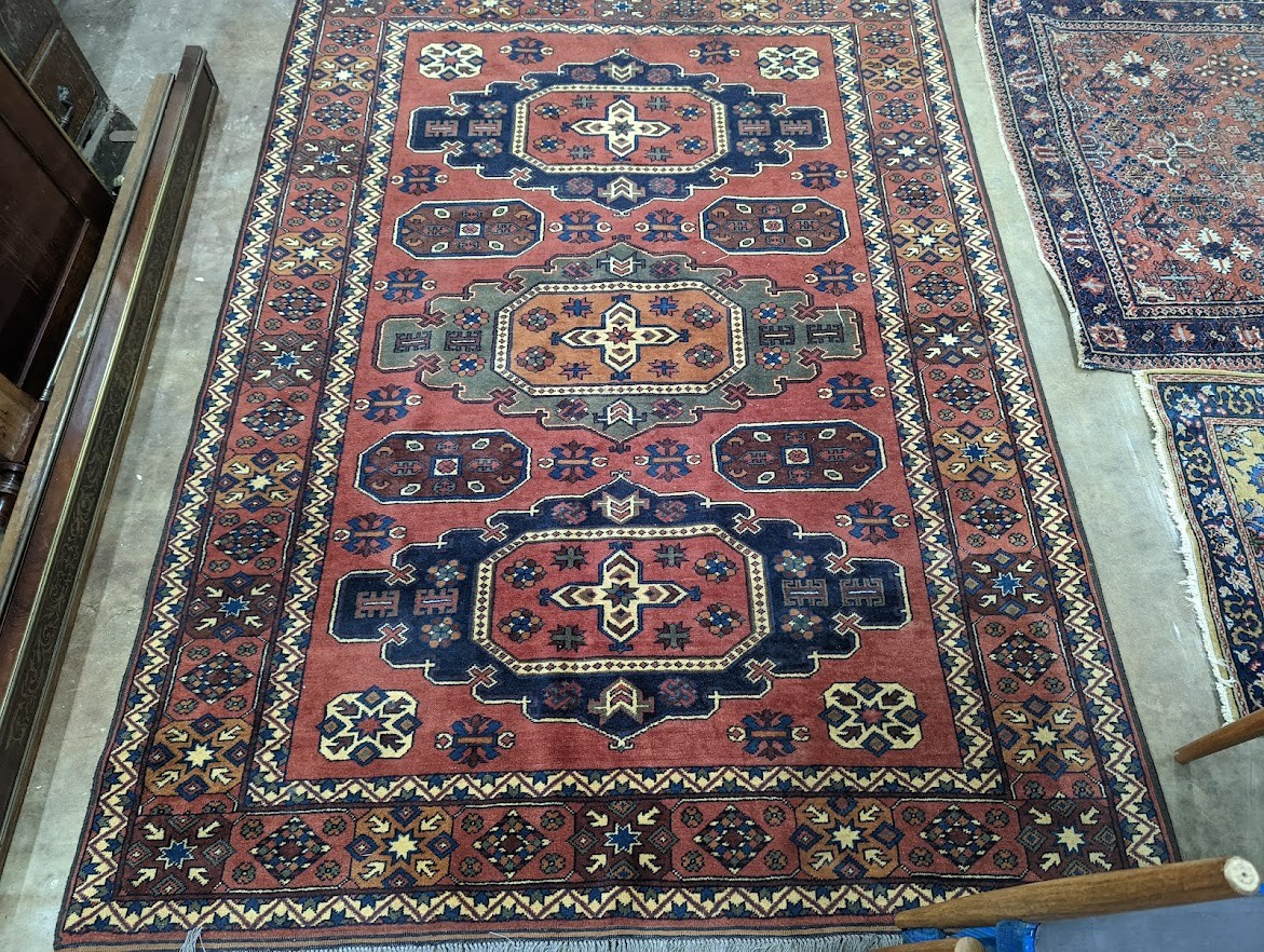 A Caucasian design red ground carpet, 240 x 176cm